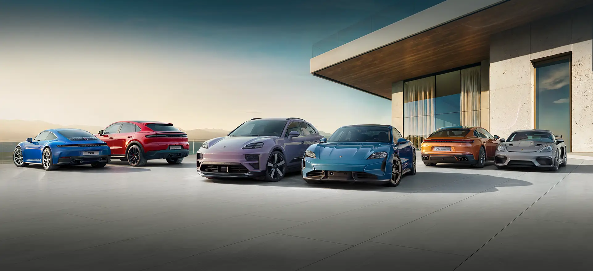 Sześć luksusowych samochodów marki Porsche zaparkowanych na nowoczesnym patio